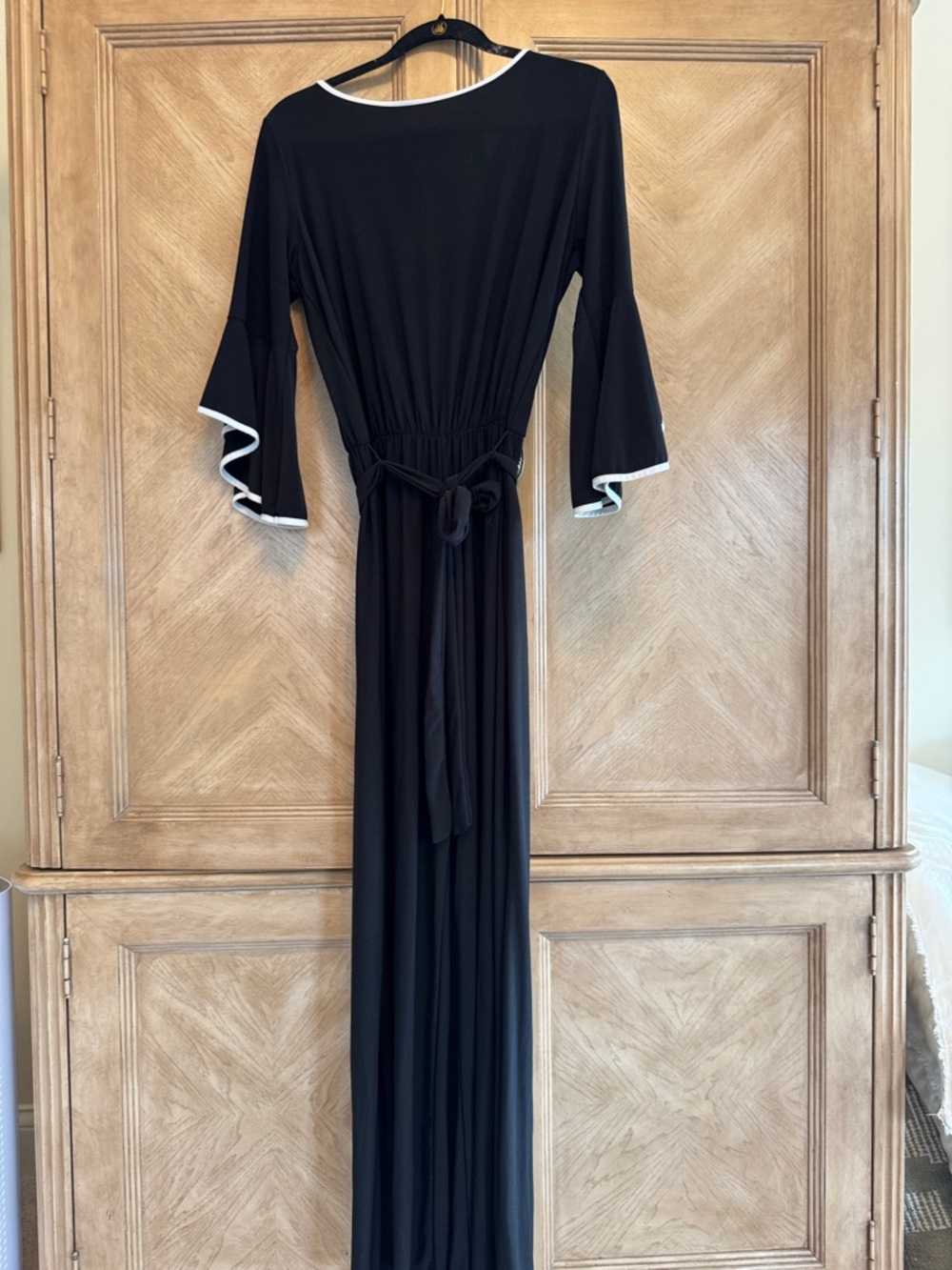Black Maxi jumpsuit with wide legs. White Trim and Tie Waist
